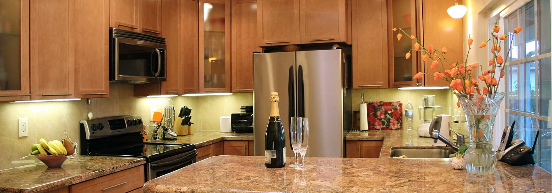Kitchen with bottle of champagne and two glasses on the counter